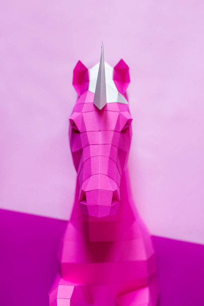 Head of a unicorn of paper on a pink and blue background. - Foto, Imagem