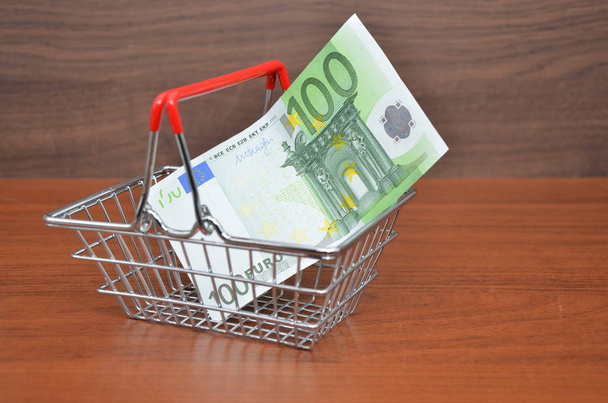 shopping cart with 100 euro note close up - Photo, Image