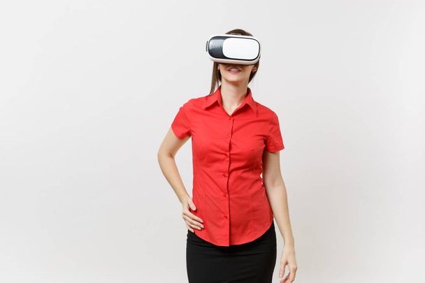 Portrait of young smart business woman in red shirt, black skirt in headset of virtual reality on head isolated on white background. Education or teaching of future in high school university concept - Φωτογραφία, εικόνα