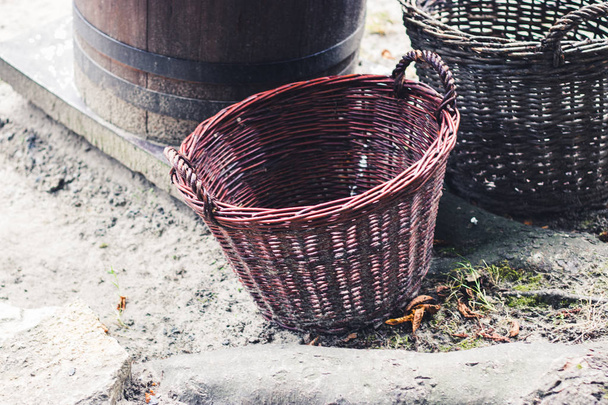 Handmade vintage village objects concept. Big empty decorative wicker baskets on market - Photo, Image