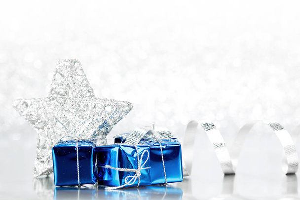 Christmas blue gifts and decoration on shiny silver background - Foto, Bild