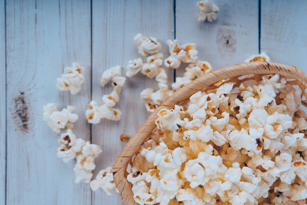 Fresh cooked Salty popcorn on wooden background - Photo, image