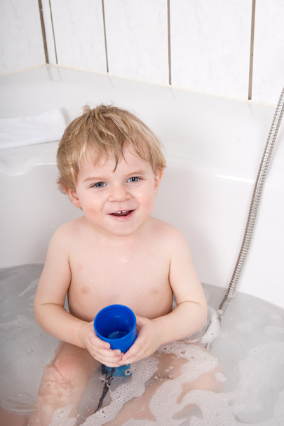 Adorable toddler boy having fun in bathtub - Photo, Image