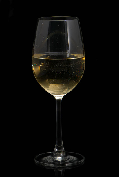 wineglass with white wine on black background - Valokuva, kuva