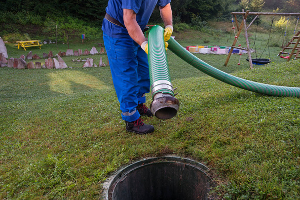 Emptying household septic tank. Cleaning and unblocking clogged drain with vacuum pipe. - Photo, Image