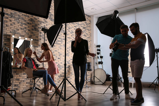 Professional team working with model in photo studio - Fotoğraf, Görsel