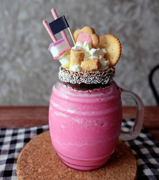 Healthy strawberry smoothie in a mason a jar mug over a rustic wood background - Zdjęcie, obraz