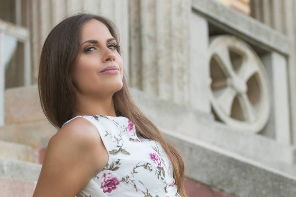 Sensual young brunette woman portrait outdoors sitting on stairs - Φωτογραφία, εικόνα