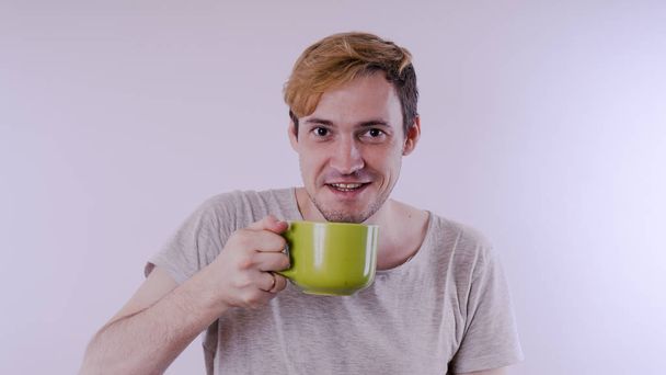 Man drink morning coffee or tea. Perfect morning with coffee. Happy guy with mulled wine on white background. - Photo, image