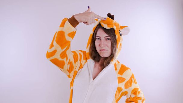 Pajamas in the shape of a giraffe. Emotional portrait of a student - Photo, Image