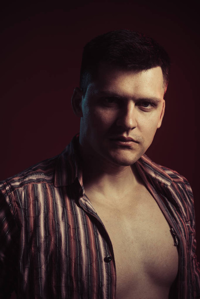 Sexy macho in open shirt show fit chest. Handsome man with stylish hair. Guy with serious face look. Style and fashion concept - Fotografie, Obrázek