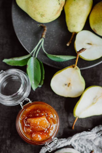 Homemade pear jam on dark background on background fresh ripe pears   - Foto, immagini