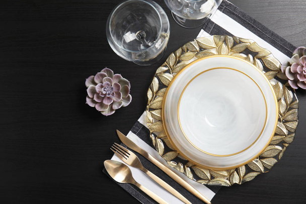 Elegant table setting on dark background, top view - Photo, image