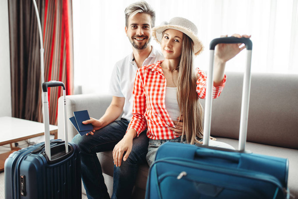 Young couple with suitcases went on a journey, man holding tickets - Photo, Image
