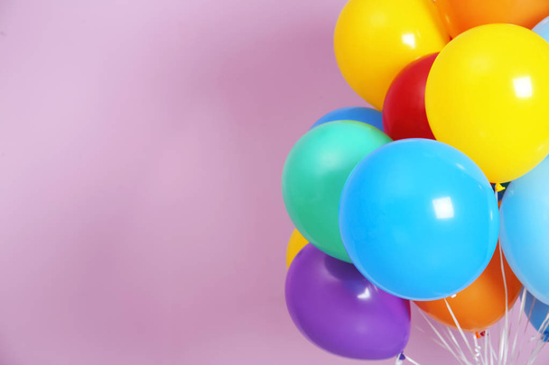 Bunch of bright balloons and space for text against color background - Foto, Imagem