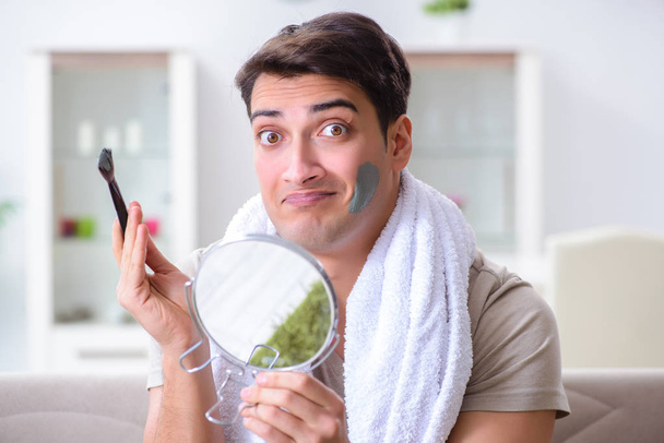 Handsome applying clay mask on face - Photo, Image