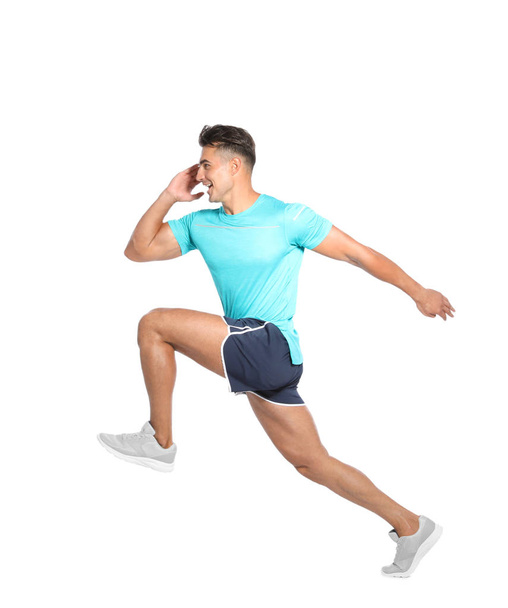 Handsome young man running on white background - Photo, image
