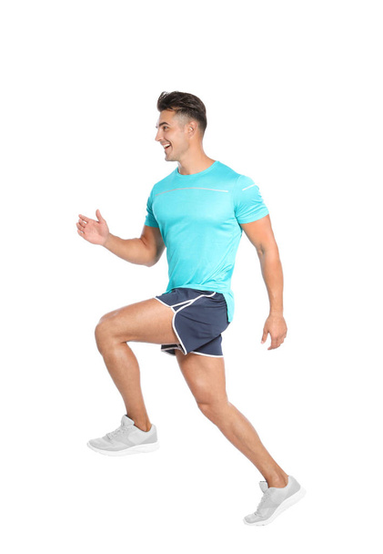 Handsome young man running on white background - Foto, afbeelding