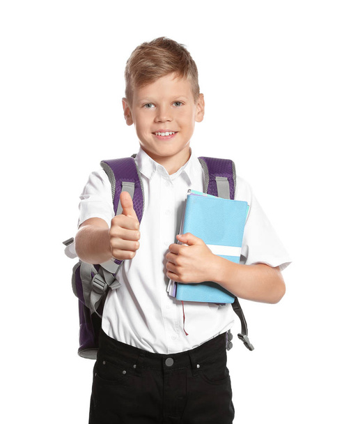 Cute boy with school stationery showing thumb up on white background - Foto, immagini