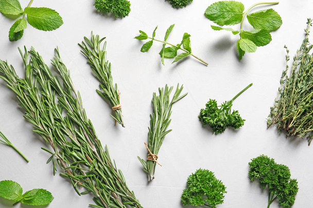 Flat lay composition with rosemary on light background. Aromatic herbs - Fotoğraf, Görsel