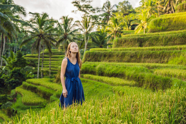 Young woman posing at Green cascade rice field plantation, Bali, Indonesia. - 写真・画像