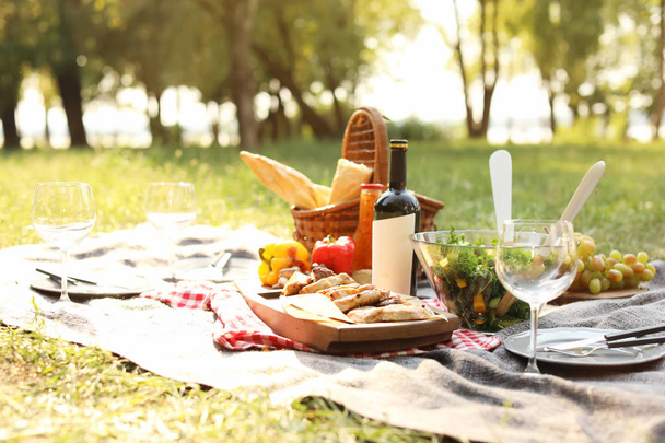 Blanket with food prepared for summer picnic outdoors - Fotografie, Obrázek