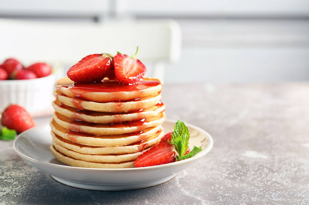 Plate with pancakes and berries on table - Foto, Bild