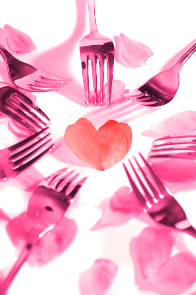 pink forks surrounding heart shape and rose petals - Photo, Image