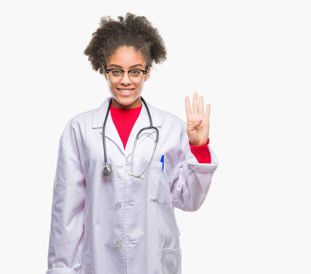 Young afro american doctor woman over isolated background showing and pointing up with fingers number four while smiling confident and happy. - Fotografie, Obrázek