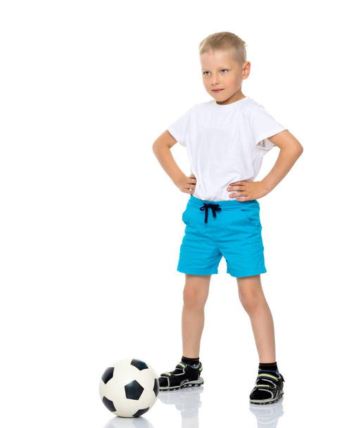 Little boy is playing with a soccer ball. - Фото, зображення