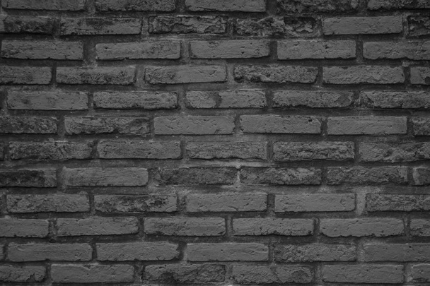 alten Muster Steinmauer Hintergrund. schwarze Ziegelwand abstrakt. raue solide Textur und Grunge-Oberfläche als Hintergrund für architektonische Materialdekoration oder Retro-Raumkonzepte. - Foto, Bild