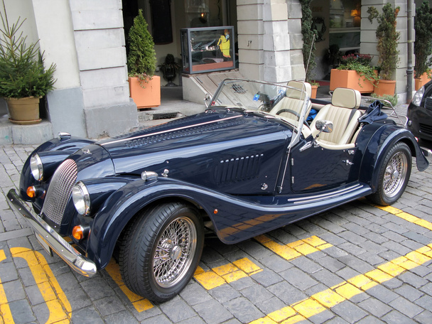 Vintage roadster on block-stone street of the historical center - Photo, Image
