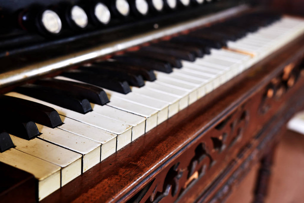 A low angle image of the keys on an old vintage upright piano.  - Photo, Image