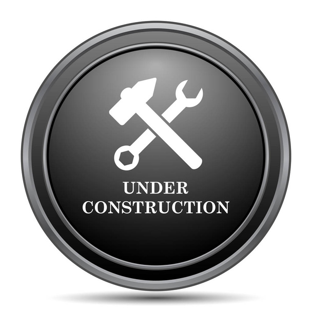 Sotto l'icona di costruzione, pulsante del sito web nero su sfondo bianco
 - Foto, immagini