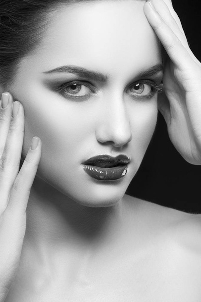 portrait of young woman with dark lips on black background - Foto, Imagem