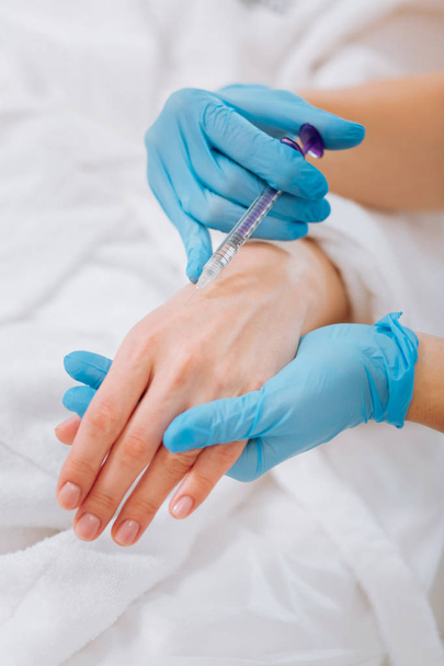 Injection being done in the female hand - Photo, Image