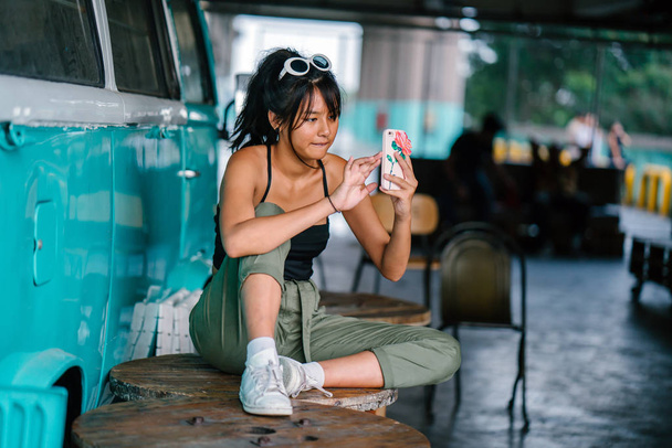 Young asian woman in casual clothes using smartphone  - Foto, Imagem