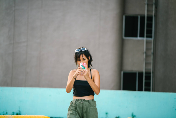 Young asian woman in casual clothes using smartphone  - Foto, Imagen