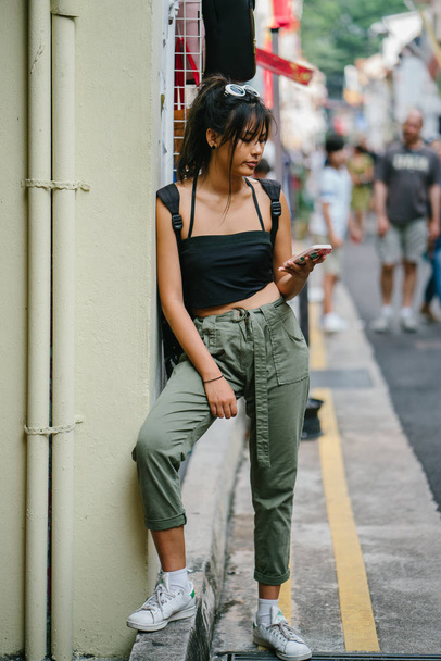 Young asian woman in casual clothes using smartphone  - Photo, image