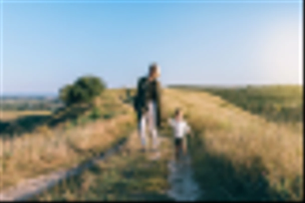 happy young mother with cute little son holding hands and walking together on rural path - 写真・画像