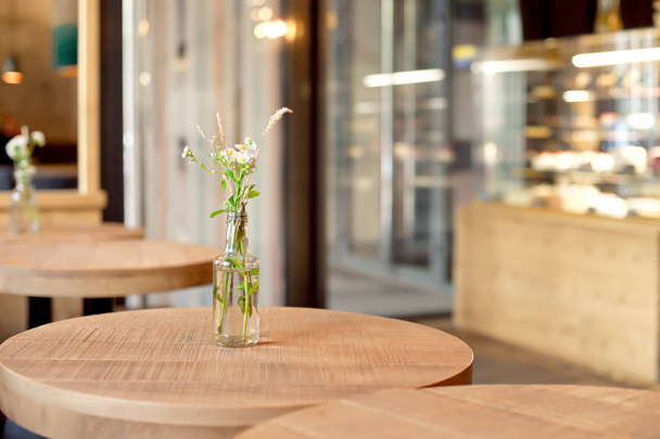 decorative bottle vase with flowers on table in modern interior  - Fotó, kép