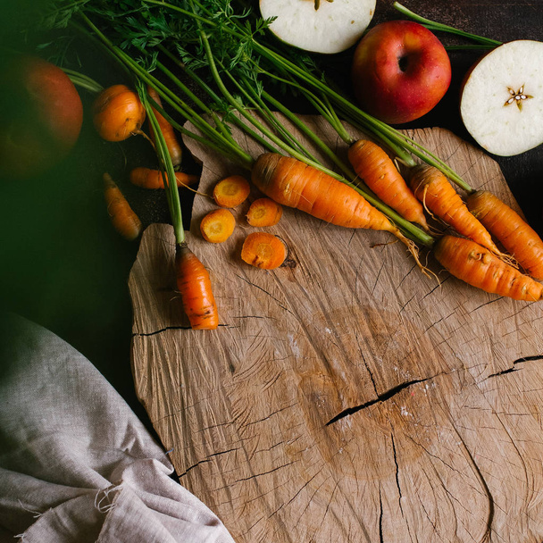 Carrots and vegetables on a dark background - Photo, image