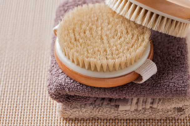 two brushes for dry body massage on towels, beauty treatment concept - 写真・画像