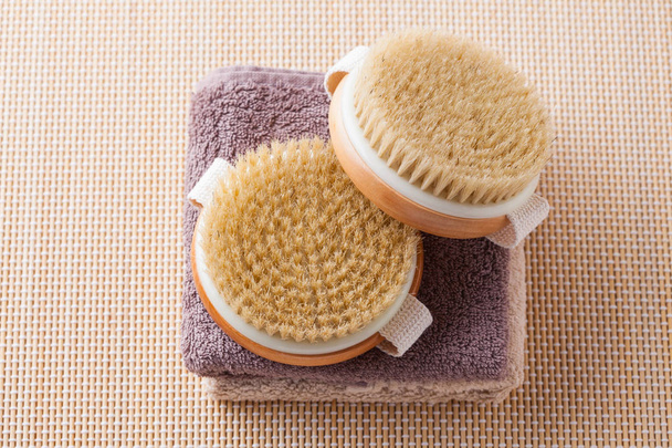 top view of two brushes for dry body massage on towels, beauty treatment concept - Photo, Image
