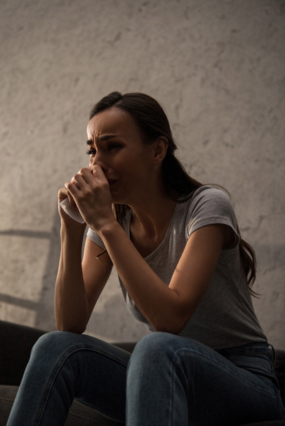 upset lonely woman crying and holding napkin at home - Fotoğraf, Görsel