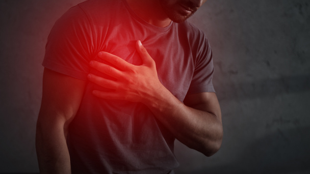 cropped view of man having heart attack with red painful point - Photo, Image
