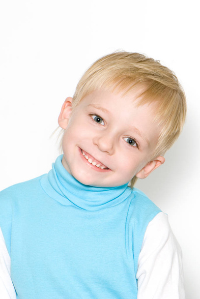 Portrait of cute blonde boy smiling isolated on white background - Фото, изображение