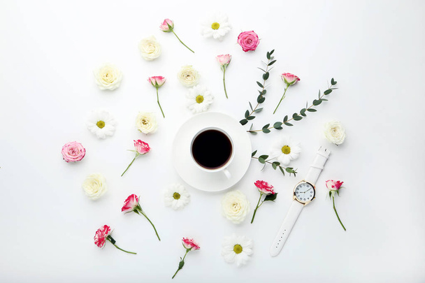 Flowers with cup of coffee and wrist watch on white background - Zdjęcie, obraz