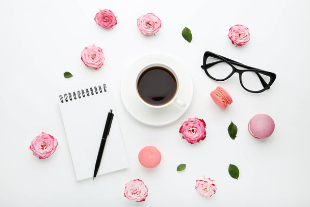 Rose flowers with cup of coffee and macarons on white background - Фото, зображення