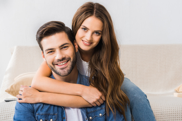 portrait of young happy couple looking at camera at home  - Photo, Image